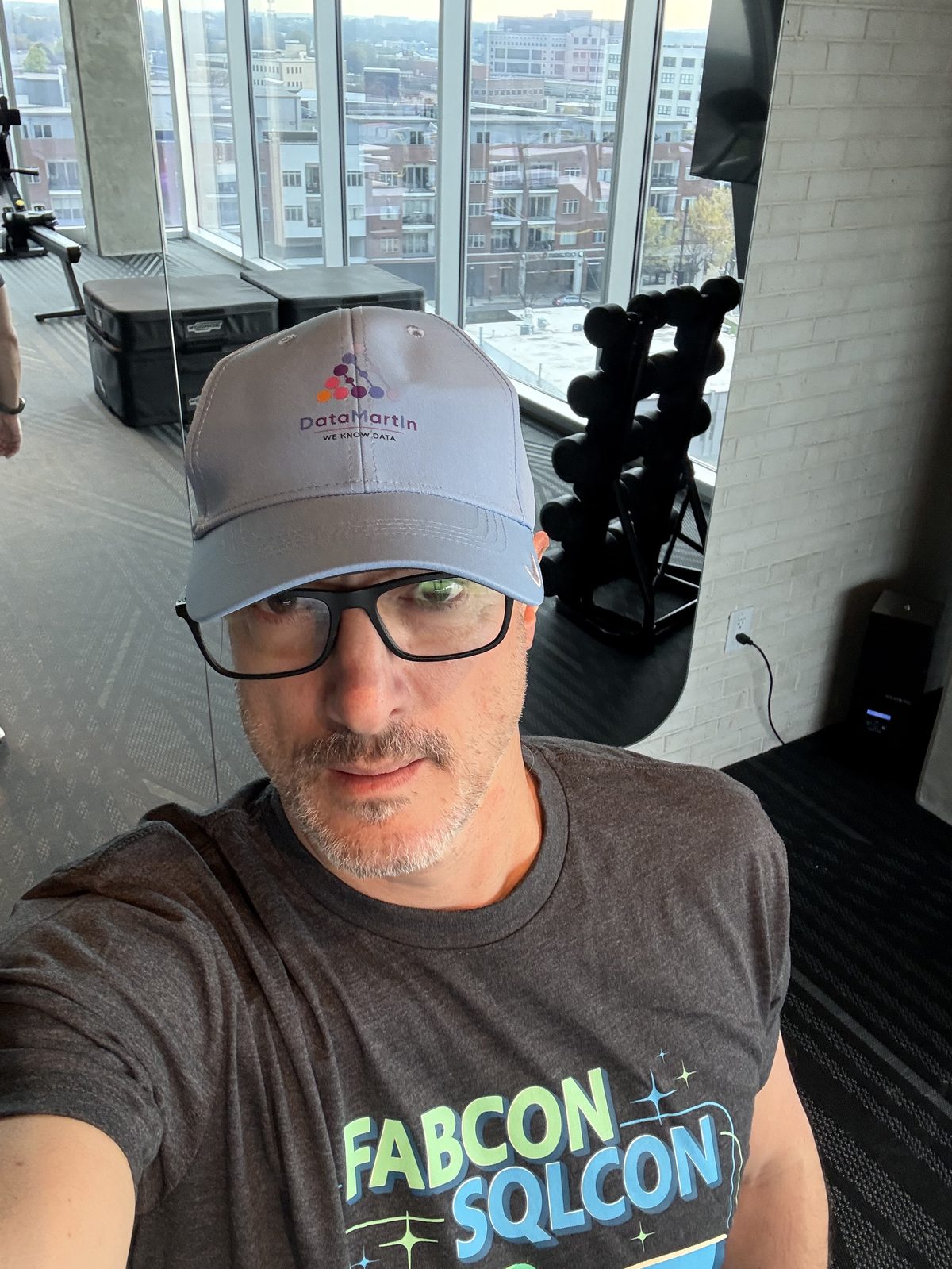 Martin Rojze wearing a DataMartIn cap and a FabCon SQLCon 2026 t-shirt